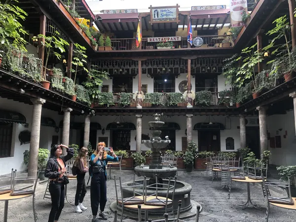 Three tourist girls exploring the Archbishop Palace in Quito